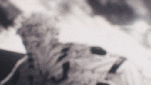 a blurred image of a person 's face with a mountain in the background