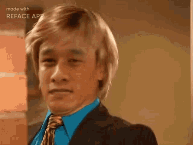a man in a suit and tie with his mouth open .