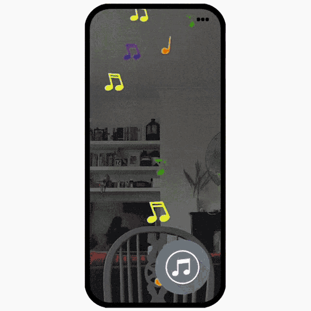 a phone screen shows a man with glasses and a music note in the corner