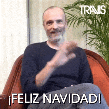 a man sitting in a chair with the words feliz navidad written on the bottom