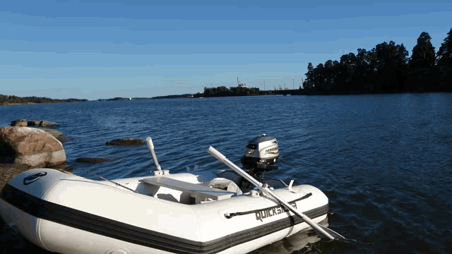 a white boat with the word quick on it