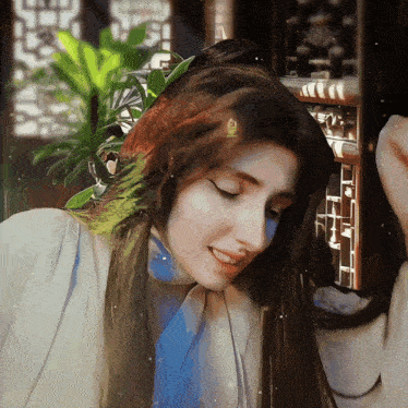a painting of a woman 's face with a plant in the background