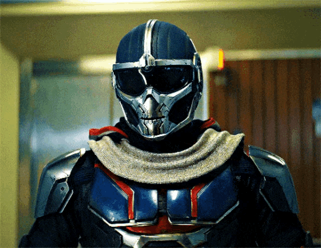 a close up of a person wearing a helmet with a skull on it
