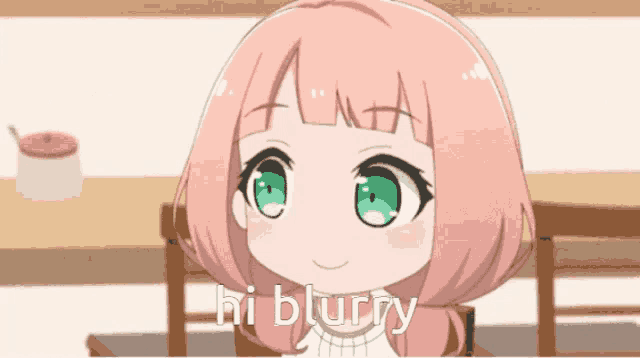 a girl with pink hair and green eyes says hi blurry in front of a table