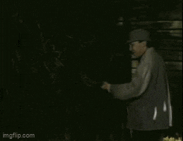 a man is standing in a dark room with imgflip.com on the bottom right