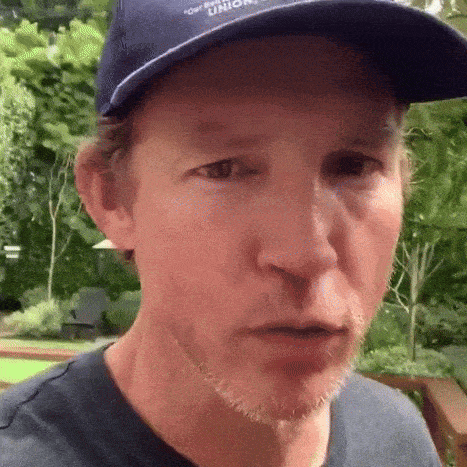 a man wearing a hat that says tommy hilfiger on it