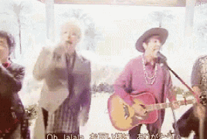 a group of people are singing and playing guitars in a band .