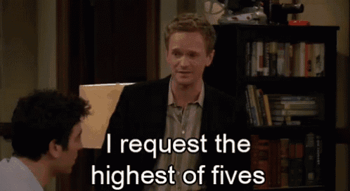 a man in a suit and tie is giving a high five .
