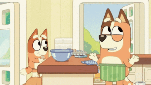 two cartoon dogs are sitting at a table with bowls of food