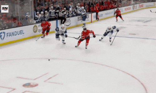 a hockey game is being played on a rink sponsored by honda great clips and boston