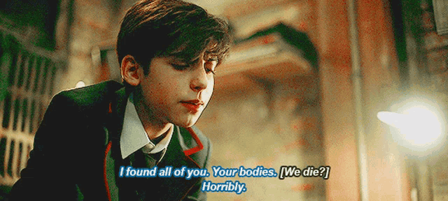 a young man in a suit says " i found all of you "
