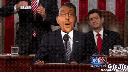 a man in a suit and tie is giving a speech at a state of the union meeting