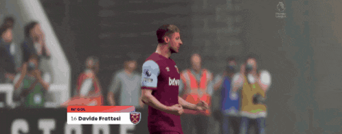 a soccer player in a maroon jersey with the word bet on the front