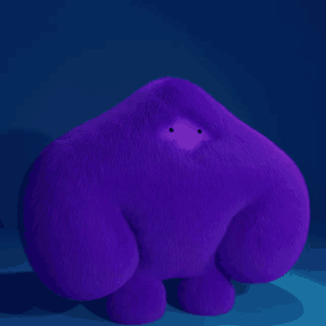 a purple stuffed animal with a small eye on it