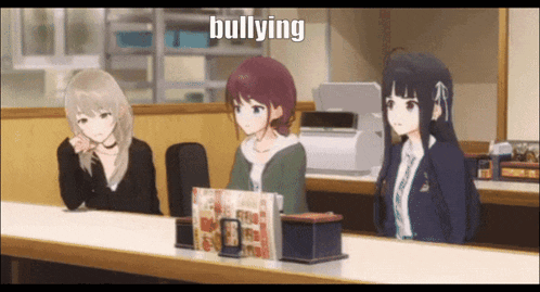 three anime girls are sitting at a table and the word bullying is on the screen