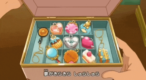 a person is holding a box that has a lot of jewelry in it and the bottom of the box has chinese writing on it
