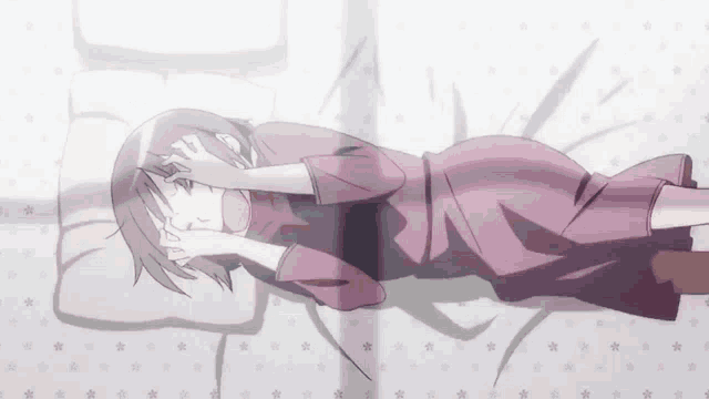 a woman in a pink dress is laying on a bed