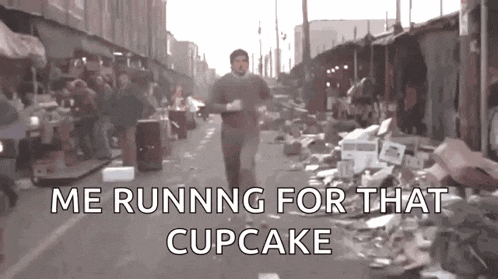 a man is running down a street with the words `` me running for that cupcake '' written on the bottom .