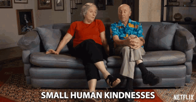 a man and a woman sit on a couch with the words small human kindnesses written on the bottom