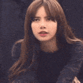 a close up of a woman making a funny face with her mouth open .