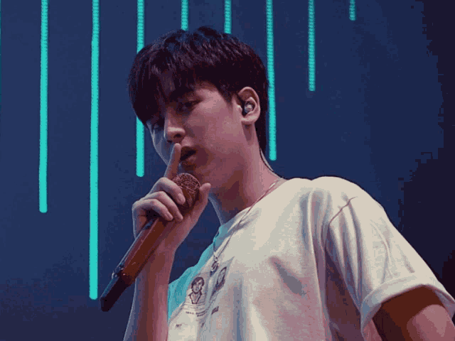 a young man singing into a microphone with eargasmh written on the bottom