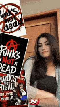 a woman is standing in front of a poster that says punk 's not dead