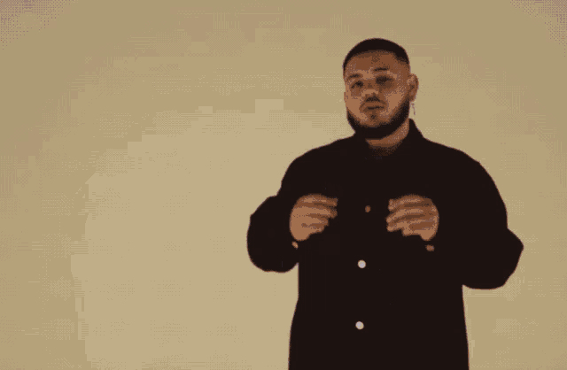 a man with a beard wearing a black shirt