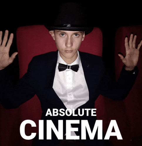 a man wearing a top hat and bow tie is sitting in a red chair with the words absolute cinema behind him