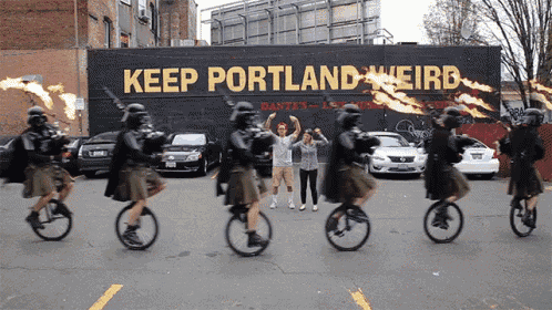 a group of people are riding bicycles in front of a wall that says keep portland weird