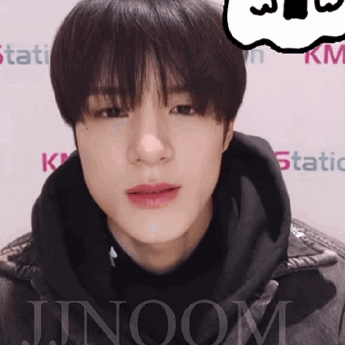 a close up of a person 's face with the word jinoom in the lower right corner