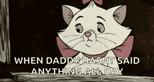 marie from the aristocats is sitting on a wooden table with her arms crossed and a bow on her head .