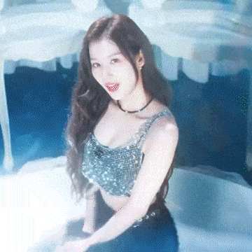 a woman with long hair is wearing a crop top and a choker necklace .