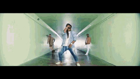 a group of people are dancing in a tunnel .