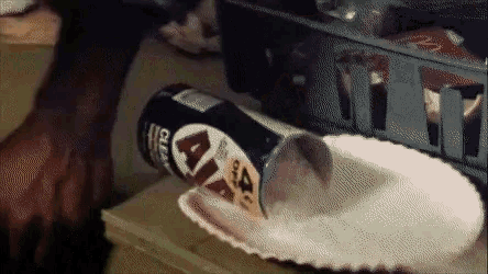 a can of lays chips is being poured into a paper plate on a table