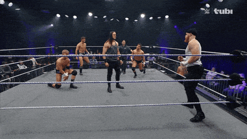 a group of wrestlers in a wrestling ring with a tubi logo
