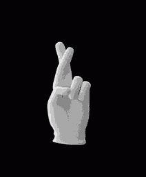 a white hand is making a crossed fingers sign