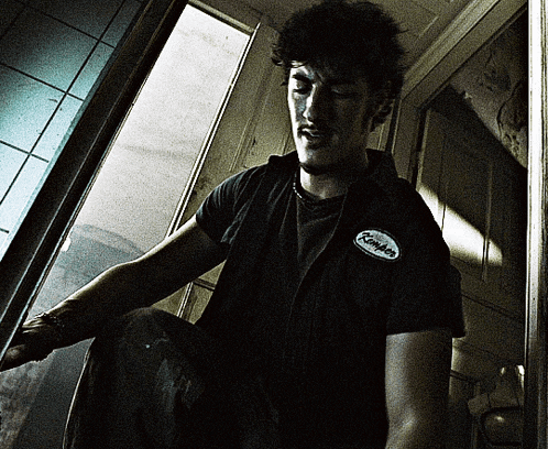 a man wearing a black shirt with a patch on his chest that says ' kimber '