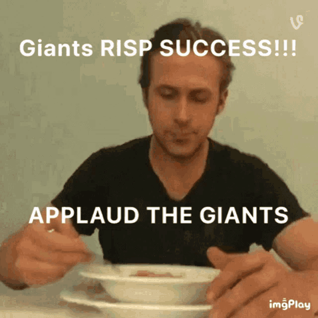 a man is sitting at a table with a bowl of food and applauds the giants