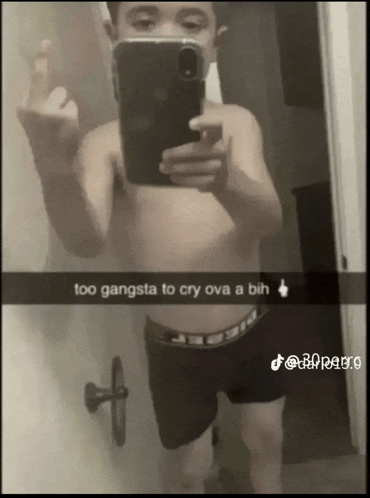 a shirtless man taking a picture of himself with the caption " too gangsta to cry ova a bih "