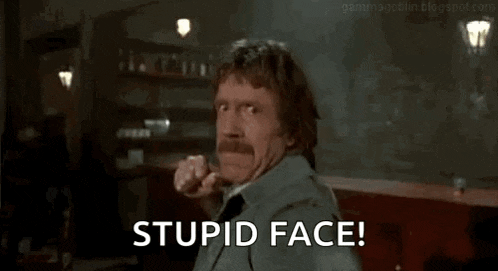 a man with a mustache is making a funny face and says `` stupid face '' .