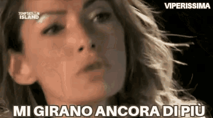 a close up of a woman 's face with the words `` mi girano ancora di più '' written on it .