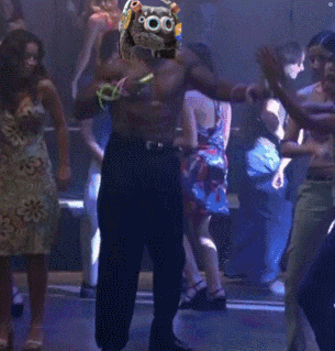 a man with a mask on his head is dancing in front of a crowd