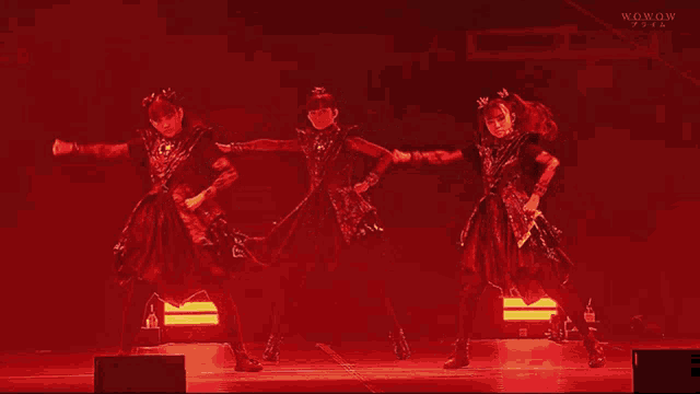 a group of girls are dancing on a stage with the words wowow written on the bottom