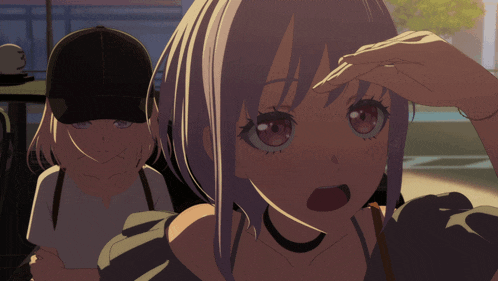 a girl with a surprised look on her face is standing next to another girl wearing a hat