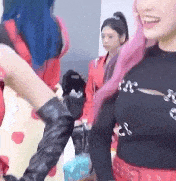 a group of women are standing next to each other in a room and holding hands .
