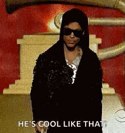 a man wearing sunglasses and a hooded jacket is standing in front of a statue and says he 's cool like that