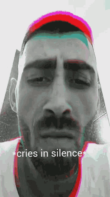 a man with a beard and mustache is crying in silence .