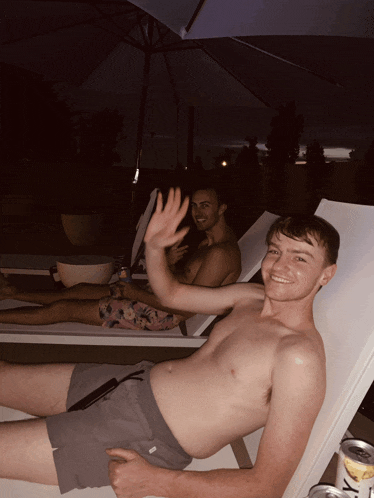a man laying on a lounge chair with a can of jack daniels
