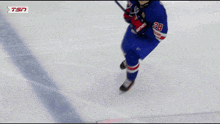 a hockey player in a blue uniform with the number 28 on it