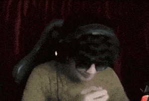 a man wearing glasses and headphones is giving a thumbs up .